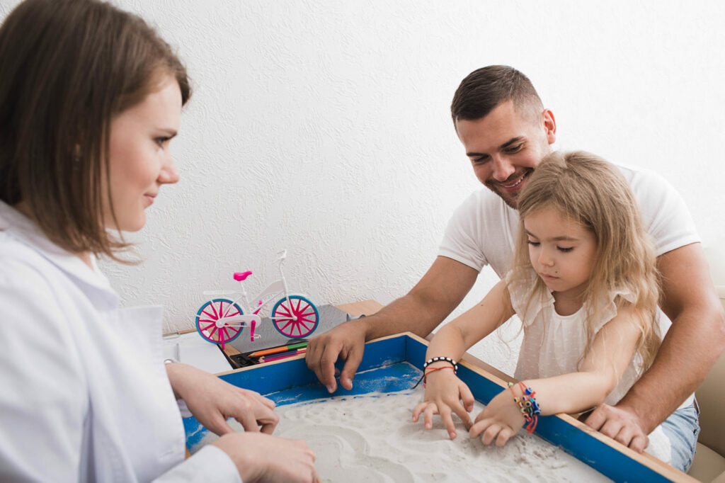 Child with father in occupational therapy.