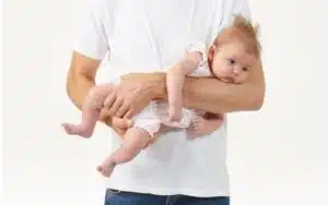 a man carrying a baby