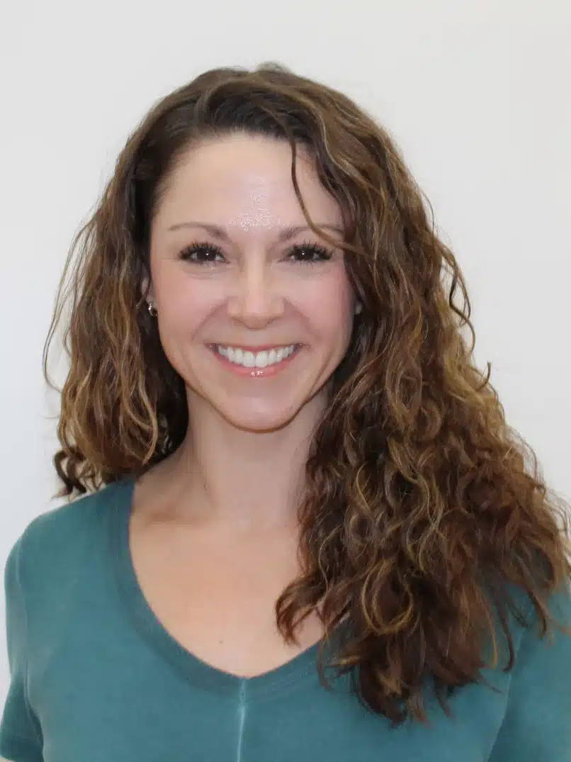 a photo of a woman smiling for a headshot